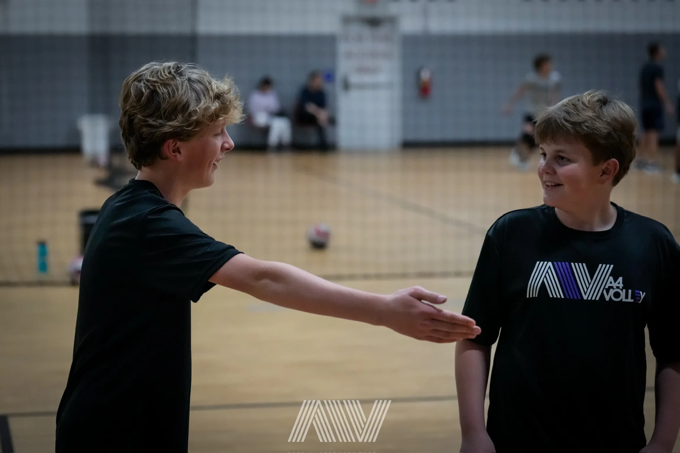 Young A4 Volleyball athlete serving during training